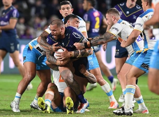 Nelson Asofa-Solomona of the Storm is challenged during the round 13 NRL match between the Melbourne Storm and the Gold Coast Titans at Sunshine...