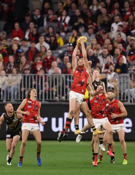 Andrew Phillips of the Bombers marks the ball during the round 12 AFL match between the Essendon Bombers and the Richmond Tigers at Optus Stadium on...