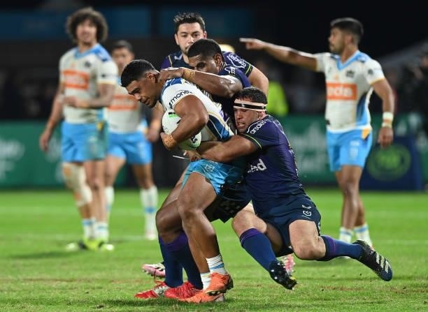 Greg Marzhew of the Titans is tackled during the round 13 NRL match between the Melbourne Storm and the Gold Coast Titans at Sunshine Coast Stadium,...