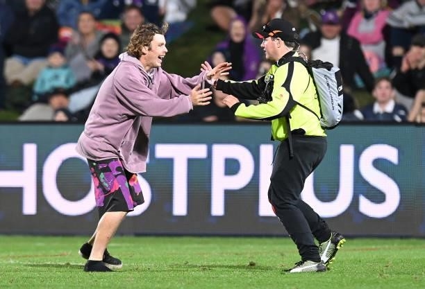 Pitch invader runs onto the ground during the round 13 NRL match between the Melbourne Storm and the Gold Coast Titans at Sunshine Coast Stadium, on...