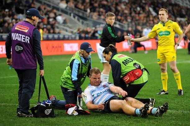 Darcy Breen of the Waratahs recieves medical assistance during the round four Super Rugby Trans-Tasman match between the Highlanders and the NSW...