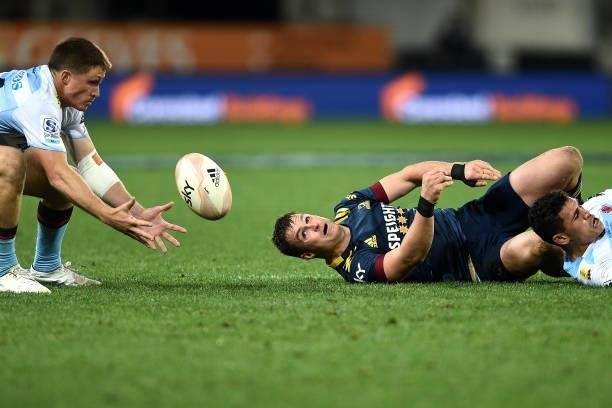 Alex Newsome of the Waratahs looks to secure the ball from Michael Collins of the Highlanders during the round four Super Rugby Trans-Tasman match...