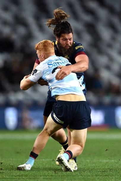 Josh Honneck of the Highlanders tackles Tane Edmed of the Waratahs during the round four Super Rugby Trans-Tasman match between the Highlanders and...