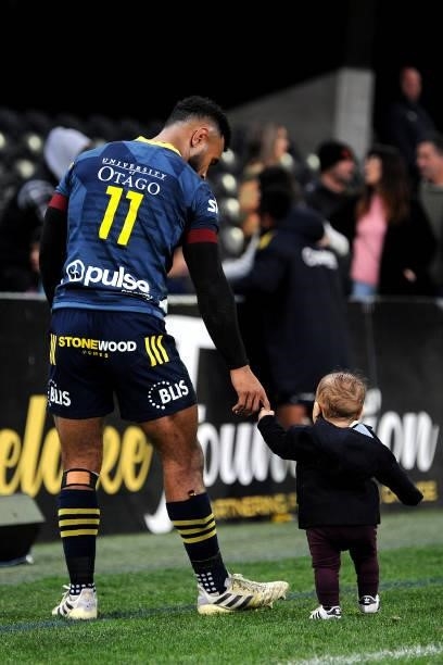 Jona Nareki of the Highlanders holds hands with his son during the round four Super Rugby Trans-Tasman match between the Highlanders and the NSW...