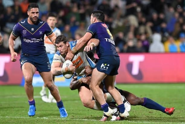 Jarrod Wallace of the Titans is tackled during the round 13 NRL match between the Melbourne Storm and the Gold Coast Titans at Sunshine Coast...