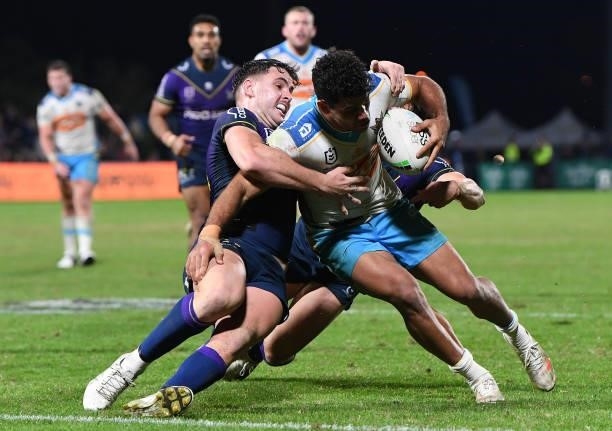 Brian Kelly of the Titans is tackled during the round 13 NRL match between the Melbourne Storm and the Gold Coast Titans at Sunshine Coast Stadium,...