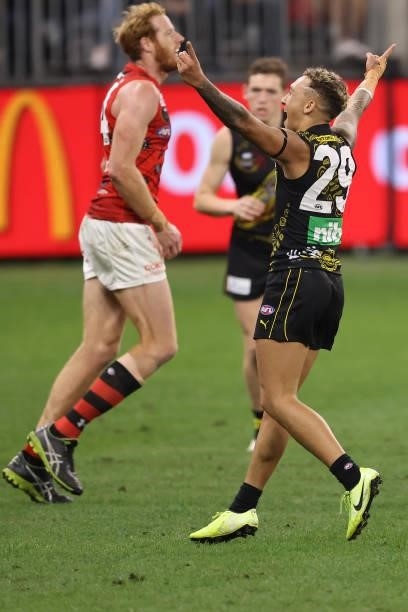 Shai Bolton of the Tigers celebrates a goal during the round 12 AFL match between the Essendon Bombers and the Richmond Tigers at Optus Stadium on...