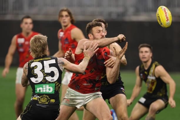 Cale Hooker of the Bombers handballs during the round 12 AFL match between the Essendon Bombers and the Richmond Tigers at Optus Stadium on June 05,...