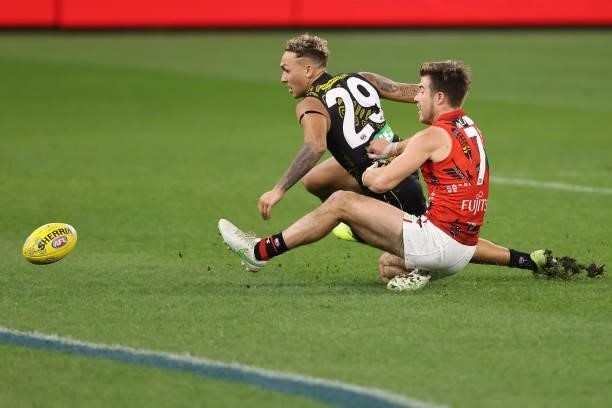 Zach Merrett of the Bombers tackles Shai Bolton of the Tigers during the round 12 AFL match between the Essendon Bombers and the Richmond Tigers at...