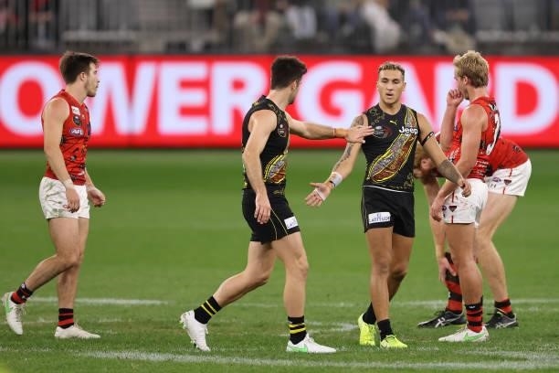 Trent Cotchin of the Tigers acknowledges Shai Bolton the round 12 AFL match between the Essendon Bombers and the Richmond Tigers at Optus Stadium on...