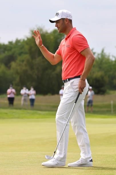 Martin Kaymer of Germany acknowledges the crowd after making a birdie on the ninth green during the first round of the Porsche European Open at Green...