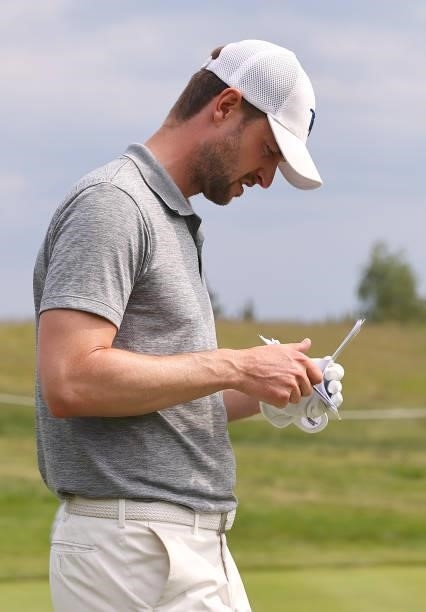 Benedict Staben of Germany cheeks his yardage book on the fifth hole during the first round of the Porsche European Open at Green Eagle Golf Course...