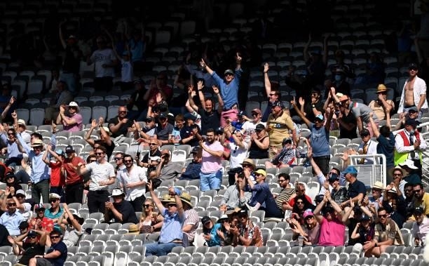 Fans react to a six from Stuart Broad of England during Day 4 of the First LV= Insurance Test Match between England and New Zealand at Lord's Cricket...