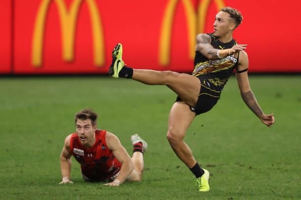 Shai Bolton of the Tigers kicks on goal during the round 12 AFL match between the Essendon Bombers and the Richmond Tigers at Optus Stadium on June...