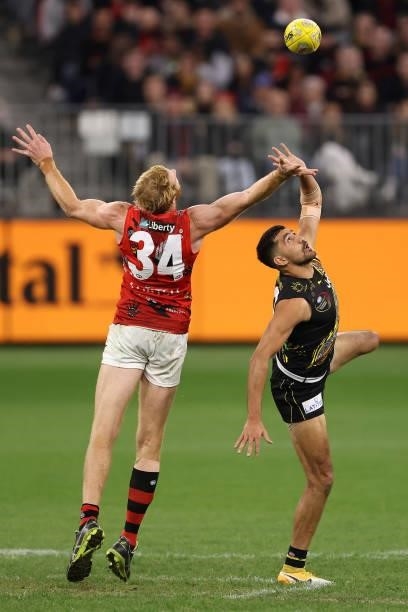 Andrew Phillips of the Bombers and Marlion Pickett of the Tigers contest the ruck during the round 12 AFL match between the Essendon Bombers and the...