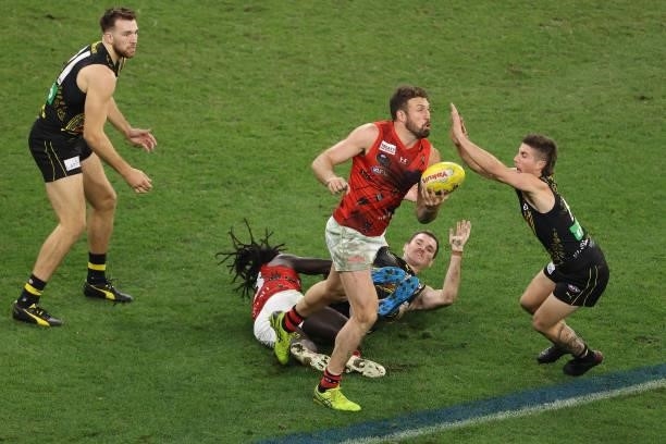 Cale Hooker of the Bombers handballs during the round 12 AFL match between the Essendon Bombers and the Richmond Tigers at Optus Stadium on June 05,...