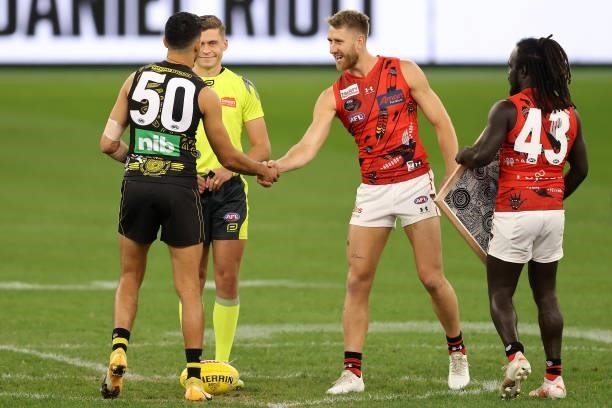 Marlion Pickett of the Tigers and Dyson Heppell of the Bombers shake hands at the coin toss during the round 12 AFL match between the Essendon...