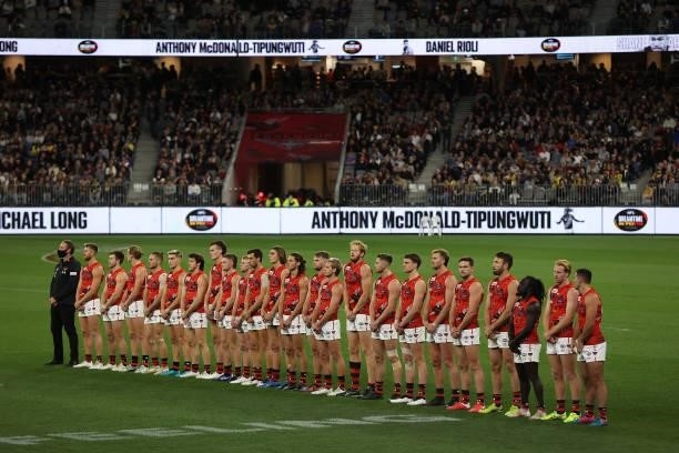 The Bombers line up before the start of the round 12 AFL match between the Essendon Bombers and the Richmond Tigers at Optus Stadium on June 05, 2021...