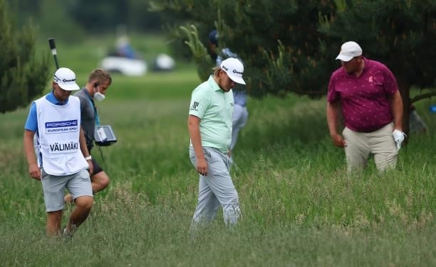 Sami Valimaki of Finland looks for his ball on the fourth hole during the first round of the Porsche European Open at Green Eagle Golf Course on June...