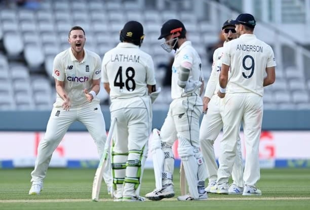 Ollie Robinson and Joe Root of England celebrate the successful review to dismiss Kane Williamson of New Zealand during Day 4 of the First LV=...