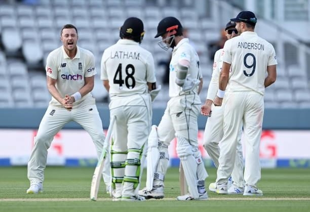 Ollie Robinson and Joe Root of England celebrate the successful review to dismiss Kane Williamson of New Zealand during Day 4 of the First LV=...