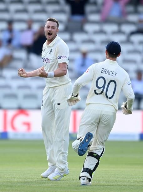 Ollie Robinson of England celebrates the successful review and dismissal of Kane Williamson of New Zealand with James Bracey during Day 4 of the...