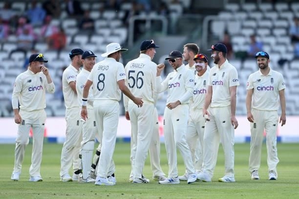 Joe Root of England celebrates with Stuart Broad and teammates after the successful review of Kane Williamson of New Zealand during Day 4 of the...
