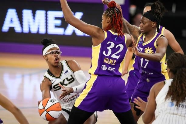 Diamond DeShields of the Chicago Sky passes the ball around Bria Holmes of the Los Angeles Sparks in the first half at Los Angeles Convention Center...