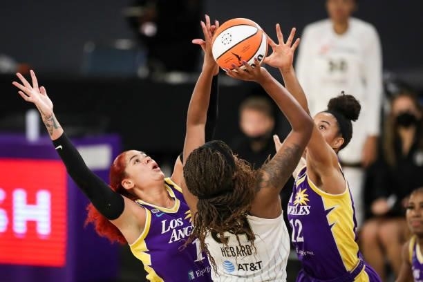Amanda Zahui B and Nia Coffey of the Los Angeles Sparks defend Ruthy Hebard of the Chicago Sky in the first half at Los Angeles Convention Center on...