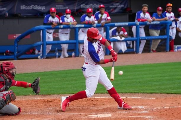 Julio Rodríguez of Dominican Republic hits a double for two rbi's to take the lead in the eighth inning against Canada during the WBSC Baseball...