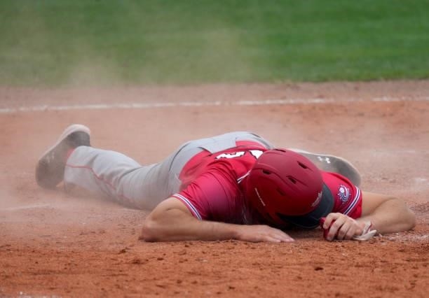 Eric Wood of Canada gets injured after sliding into homeplate for a score in the eighth inning against the Dominican Republic during the WBSC...
