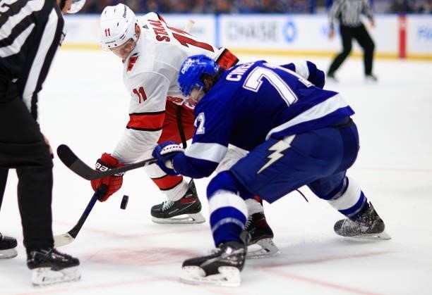 Jordan Staal of the Carolina Hurricanes and Anthony Cirelli of the Tampa Bay Lightning face off during Game Four of the Second Round of the 2021...