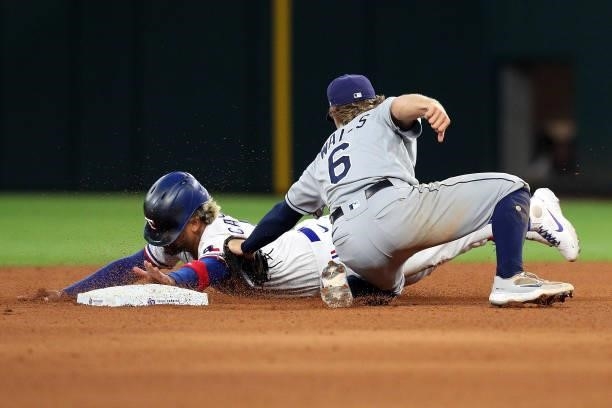 Taylor Walls of the Tampa Bay Rays makes the tag on Willie Calhoun of the Texas Rangers for an out in the eighth inning at Globe Life Field on June...