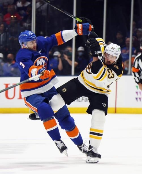 Brad Marchand of the Boston Bruins is hit by Adam Pelech of the New York Islanders during the first period in Game Four of the Second Round of the...