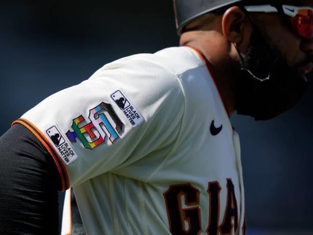 First Base Coach Antoan Richardson of the San Francisco Giants looks on while wearing a jersey with patches saying "Black Lives Matter