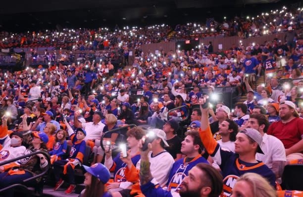 Fans hold up their lights prior to the game between the New York Islanders and the Boston Bruins in Game Four of the Second Round of the 2021 NHL...