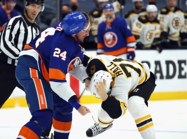 Taylor Hall of the Boston Bruins and Scott Mayfield of the New York Islanders fight during the first period in Game Four of the Second Round of the...