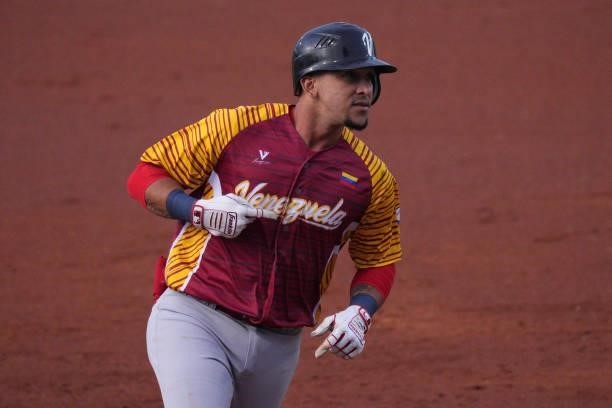 Hernán Pérez of Venezuela points to the name on his jersey while runing the bases after hitting a solo homerun in the third inning against the United...