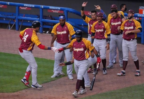 Hernán Pérez of Venezuela celebrates with teammates after hitting a solo homerun in the third inning against the United States during the WBSC...