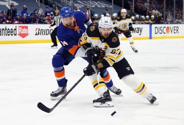Brad Marchand of the Boston Bruins carries the puck against Travis Zajac of the New York Islanders during the first period in Game Four of the Second...