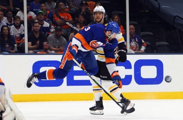 Adam Pelech of the New York Islanders jumps into David Pastrnak of the Boston Bruins during the first period in Game Four of the Second Round of the...