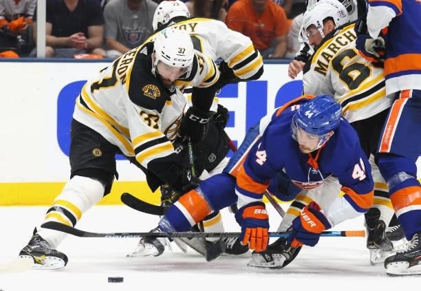 Patrice Bergeron of the Boston Bruins and Jean-Gabriel Pageau of the New York Islanders battle for the puck during the second period in Game Four of...