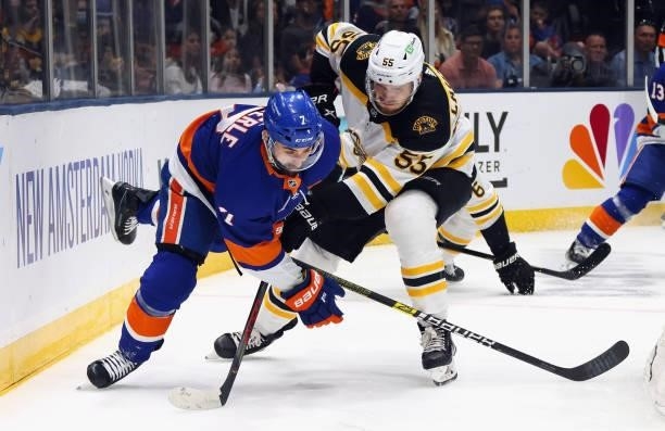 Jeremy Lauzon of the Boston Bruins slows down Jordan Eberle of the New York Islanders during the second period in Game Four of the Second Round of...