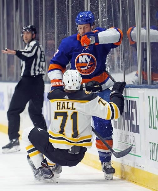 Matt Martin of the New York Islanders checks Taylor Hall of the Boston Bruins during the second period in Game Four of the Second Round of the 2021...