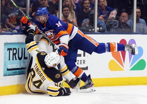 Travis Zajac of the New York Islanders checks Jarred Tinordi of the Boston Bruins during the second period in Game Four of the Second Round of the...