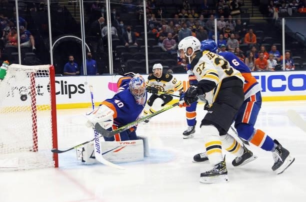 Semyon Varlamov of the New York Islanders makes the third period save as Patrice Bergeron of the Boston Bruins looks for the rebound in Game Four of...
