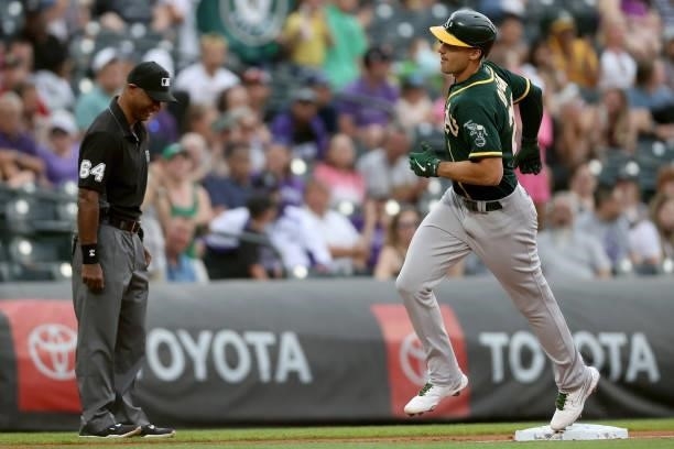 Matt Olson of the Oakland Athletics circles the bases after hitting a 2 RBI home run against the Colorado Rockies in the first inning at Coors Field...