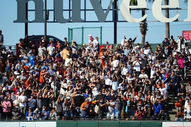 Fans celebrate a home run by Alex Dickerson of the San Francisco Giants during the game between the Chicago Cubs and the San Francisco Giants at...