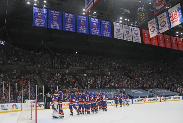 The New York Islanders celebrate their 4-1 win over the Boston Bruins in Game Four of the Second Round of the 2021 NHL Stanley Cup Playoffs at the...