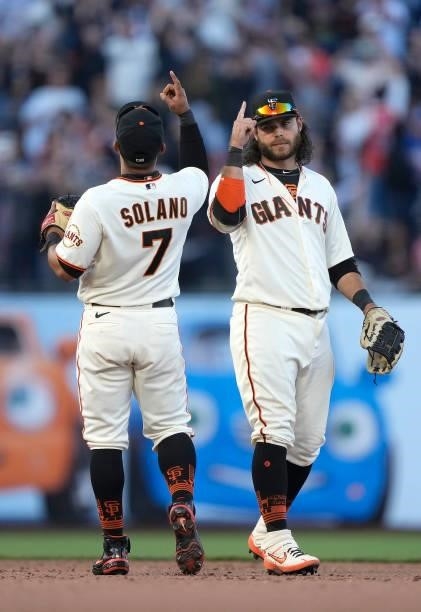 Donovan Solano and Brandon Crawford of the San Francisco Giants celebrates defeating the Chicago Cubs 4-3 at Oracle Park on June 05, 2021 in San...